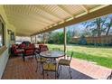 Enjoy outdoor dining on the brick patio, complete with comfortable seating and lush backyard view at 3844 S Elm St, Denver, CO 80237