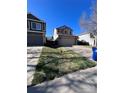 A single-Gathering home with a well-manicured lawn and attached garage on a sunny day at 1062 Timbervale Trl, Highlands Ranch, CO 80129