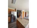 Modern kitchen with stainless steel appliances, an island and wood cabinets at 1062 Timbervale Trl, Highlands Ranch, CO 80129