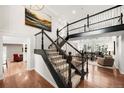 Grand foyer with staircase, hardwood floors, and a view into the living room at 4833 E Links Cir, Centennial, CO 80122