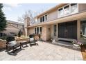Inviting front porch featuring outdoor seating, brick accents, and a double-door entryway at 4833 E Links Cir, Centennial, CO 80122
