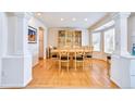 Bright dining room features hardwood floors, a large window, and elegant display cabinet at 1011 S Valentia St # 147, Denver, CO 80247