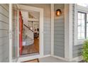 Inviting entryway featuring a bright red door, and showing the home's open staircase and interior living area at 4279 Brandon Ave, Broomfield, CO 80020