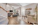 Cozy living room featuring vaulted ceilings, a fireplace, hardwood floors, and comfortable seating at 4279 Brandon Ave, Broomfield, CO 80020