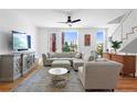 Bright living room featuring a comfortable sectional sofa, modern furnishings, and hardwood flooring at 2150 S Delaware St, Denver, CO 80223