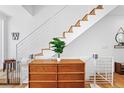 Bright staircase and open landing features wood stairs and white modern railing at 2150 S Delaware St, Denver, CO 80223