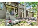 Inviting home entrance with wooden porch, stairs, and flower pot accents at 1927 Sunset Cir, Evergreen, CO 80439