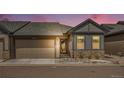Charming single-Gathering home featuring a two-car garage, stone accents, and a beautifully landscaped front yard at 11791 Barrentine Loop, Parker, CO 80138
