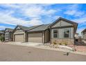 Charming home featuring stone accents, a well-kept lawn, and attached two-car garages at 11791 Barrentine Loop, Parker, CO 80138