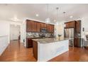Modern kitchen with stainless steel appliances, granite countertops, and a large island at 11791 Barrentine Loop, Parker, CO 80138
