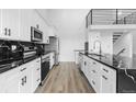 Modern kitchen featuring white cabinets, black hardware and marble countertops at 6519 Pinewood Dr, Parker, CO 80134