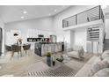 Open-concept living space with a modern kitchen, dining area, and comfortable seating at 6519 Pinewood Dr, Parker, CO 80134