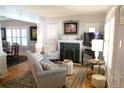 Elegant living room with fireplace, neutral tones, and ample natural light at 832 S Gilpin St, Denver, CO 80209