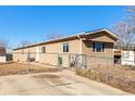 Charming home exterior showcasing a well-maintained yard, a metal fence, and a driveway leading to the property at 119 Yakima St, Lochbuie, CO 80603