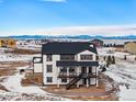 Two-story home with expansive back deck and mountain views; aerial shot at 3654 Paintbrush Ln, Parker, CO 80138