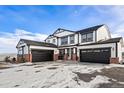 Two-story home with a three-car garage and brick accents at 3654 Paintbrush Ln, Parker, CO 80138