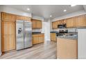 Modern kitchen with stainless steel appliances, granite countertops, and ample cabinet space at 6735 W 97Th Cir, Westminster, CO 80021