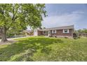 Inviting brick home on a spacious lot with mature trees providing ample shade at 10633 E 6Th Pl, Aurora, CO 80010