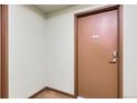 Condominium door with unit number and secure entry features at 15475 Andrews Dr # 318, Denver, CO 80239