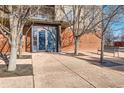 Condominium entrance with secure door, sidelights and trees in sidewalk tree wells at 15475 Andrews Dr # 318, Denver, CO 80239