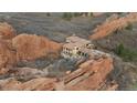 Magnificent home surrounded by a dramatic landscape of imposing red rock formations at 3755 N Rampart Range Rd, Littleton, CO 80125