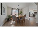 Dining room with a wood table set and a chandelier, brightened by natural light at 11570 Depew Ct, Westminster, CO 80020