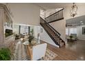 A well-lit living room features hard wood floors, a staircase, and an open dining room at 11570 Depew Ct, Westminster, CO 80020