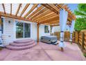 Backyard patio featuring a pergola with string lights and curtains, a hot tub, and sliding door access to the house at 449 Vista Blvd, Lochbuie, CO 80603