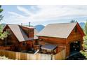 Cabin featuring wood siding and a fenced-in backyard at 750 Cougar Dr, Boulder, CO 80302
