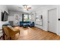 Bright living room with hardwood floors, and an adjacent kitchen at 1356 N Pearl St # 109, Denver, CO 80203