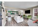 Open-concept living room with hardwood floors, abundant natural light, and modern furnishings at 600 Avalon Ave, Lafayette, CO 80026