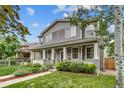 Well-manicured lawn and front yard landscaping complement this charming two-story home at 3937 Osceola St, Denver, CO 80212