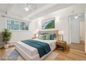 Comfortable bedroom featuring a large window, hardwood floors, and stylish decor at 250 N Pearl St # 310, Denver, CO 80203