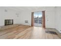 Cozy living room features hardwood floors, decorative fireplace, and sliding glass doors at 250 N Pearl St # 310, Denver, CO 80203