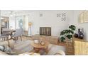 Inviting living room featuring a brick fireplace, light wood floors, and ample natural light at 250 N Pearl St # 310, Denver, CO 80203