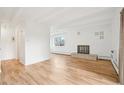 Spacious living room with light wood floors, a brick fireplace, and lots of natural light at 250 N Pearl St # 310, Denver, CO 80203