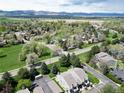 Scenic aerial view of townhomes with mountain backdrop, surrounded by trees and greenery at 6899 Countryside Ln # 269, Niwot, CO 80503