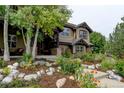 Charming home featuring a welcoming front porch and lush landscaping with stone accents at 2121 Jade Way, Longmont, CO 80504