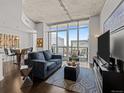 Stylish living room with floor-to-ceiling windows, city views, and contemporary furnishings at 891 14Th St # 3411, Denver, CO 80202