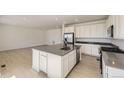 Spacious kitchen featuring stainless steel appliances, white cabinets, and a large center island at 2184 S Gold Bug Ct, Aurora, CO 80018