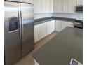 Modern kitchen with white cabinets, stainless steel appliances, and a gray countertop at 2184 S Gold Bug Ct, Aurora, CO 80018