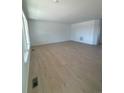 Open concept living room with wood-look flooring and plenty of natural light at 2184 S Gold Bug Ct, Aurora, CO 80018