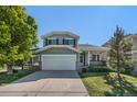 Charming two-story home with a well-manicured lawn, mature trees, and a two-car garage at 5405 Military Trl, Parker, CO 80134