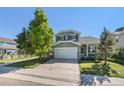 Charming two-story home with a well-manicured lawn, mature trees, and a two-car garage at 5405 Military Trl, Parker, CO 80134