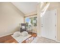 Bright foyer with hardwood floors, neutral walls, a reading chair and a large window at 5405 Military Trl, Parker, CO 80134