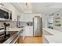 Modern kitchen features stainless steel appliances, white countertops, and grey subway tile backsplash at 33 N Corona St # 401, Denver, CO 80218