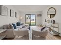 Comfortable living room featuring a sofa, chairs, and a sliding glass door to the outside at 7770 W 38Th Ave # 108, Wheat Ridge, CO 80033