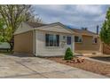 Exterior side and front view featuring a combination of siding and brick, complemented by a concrete driveway at 7828 Florado St, Denver, CO 80221
