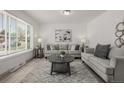 Bright living room with neutral decor, stylish furniture, and a large window for plenty of natural light at 7828 Florado St, Denver, CO 80221