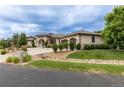 Beautiful stone home featuring a private driveway and three-car garage, all on a sprawling lawn at 5767 Pelican Shores Dr, Longmont, CO 80504